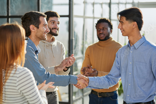 friendly hr manager or team leader greeting or welcoming new worker