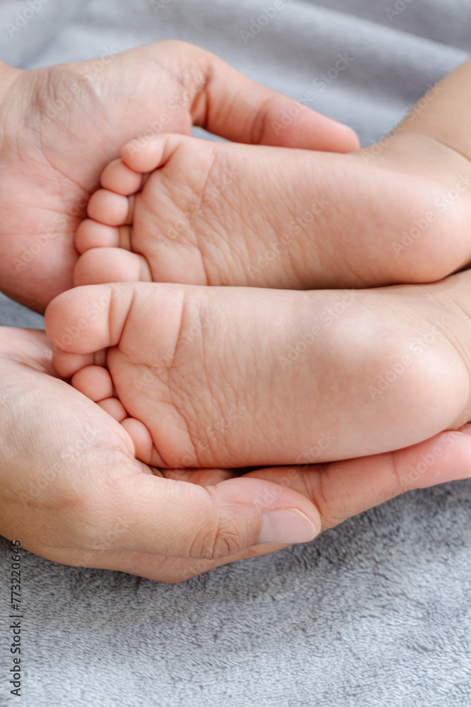 Baby feet close up,A close-up of tiny baby feet,Baby feet on white coverlet. Toes. Feet how a heart or Baby feet close up,A close-up of tiny baby feet,Baby feet on white coverlet. Toes. Feet how a heart or
