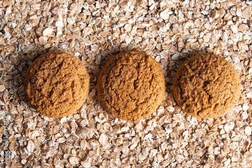 Round brown oatmeal cookies on the oat flakes