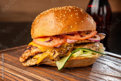 Burger on a wooden board with drink