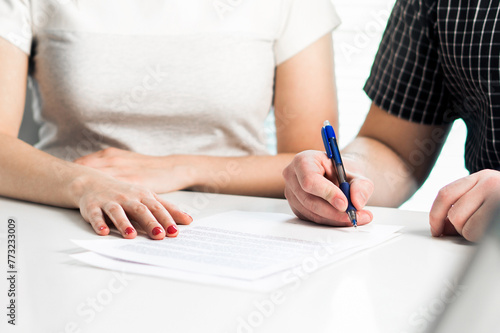 Divorce agreement. Couple signing legal document. Prenuptial marriage settlement, prenup. Lawyer meeting. Separation, breakup or lawsuit after family conflict. Obligation, alimony or custody contract. photo