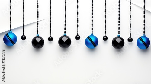 Minimalist design of alternating blue and black pendulum baubles on a white-to-gray gradient background, conveying modern elegance.