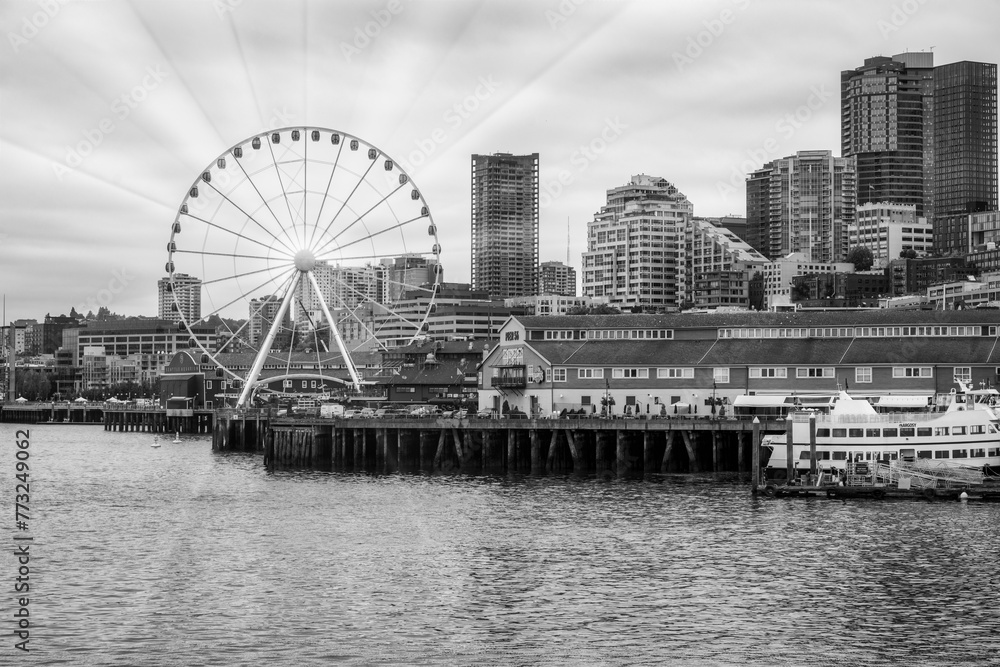 2023-12-31 THE SEATTLE WATER FRONT WITH OFFICE TOWERS THE GREAT WHEEL NEXT TO PIER 54 ON ELLIOTT BAY