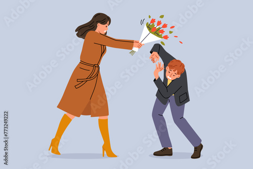 Woman hits groom with bouquet because of betrayal and finding out fact of adultery. Conflict between man and angry girlfriend, reacting negatively to advances or gifts, after adultery photo