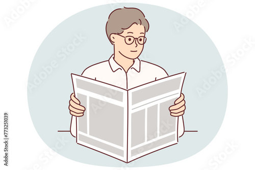 Man holds newspaper reading news about latest business events and political changes or articles
