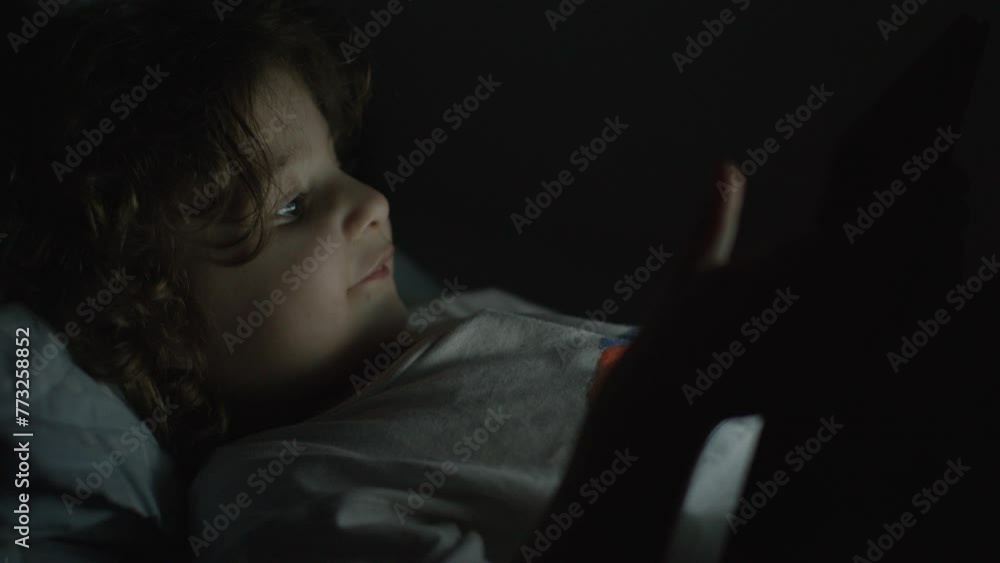 Boy enjoy digital tablet at night Boy enjoy digital tablet at night