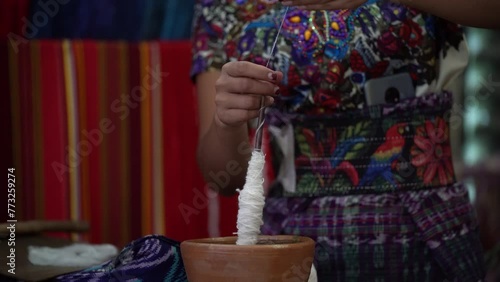 Indigena preparando el hilo para tejer la ropa tipica de Guatemala photo