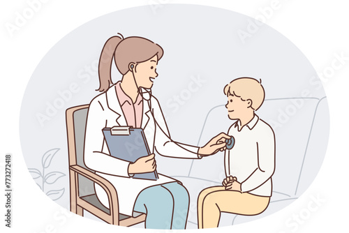 Woman pediatrician uses stethoscope listening to heartbeat of child during pre-school checkup