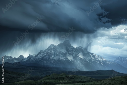 A large mountain is covered in a cloud-filled sky as a dramatic rainstorm approaches  with dark heavy clouds looming overhead