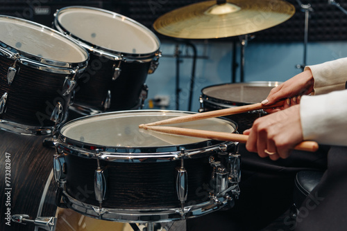 young woman playing drum set