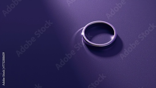 Minimalist image of a ring on a purple surface. photo