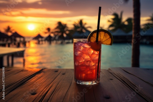 Colorful cocktail or juice in a glass decorated on a wooden table on blurred seascape background