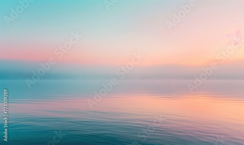 The soft pastel colors of dawn breaking over the horizon