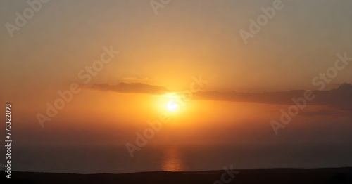 Stunning landscape of a golden sun setting over the horizon of a tranquil blue ocean