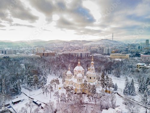 Ascension Cathedral in the Park of 28 Panfilovites in Almaty. Old historical building made of wood in the center of Almaty. Popular tourist place in the snow. Aerial photography of the church. photo