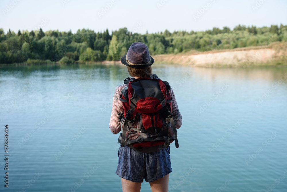 tourist girl standing on edge of hill looking at mounting lake tourist girl standing on edge of hill looking at mounting lake