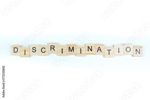 discrimination- word composed fromwooden blocks letters on White background, copy space for ad text. photo