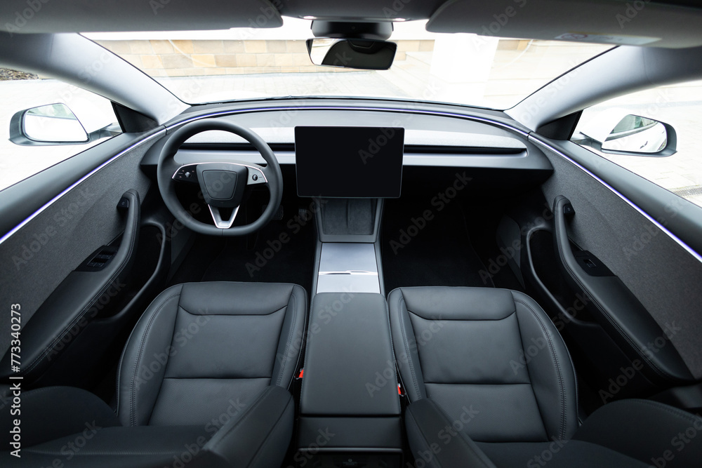 Electric car interior details adjustments. Inside car interior with front seats, driver and passenger, textile, multimedia, windows, console, gear shift, electric buttons, digital speedometer Electric car interior details adjustments. Inside car interior with front seats, driver and passenger, textile, multimedia, windows, console, gear shift, electric buttons, digital speedometer