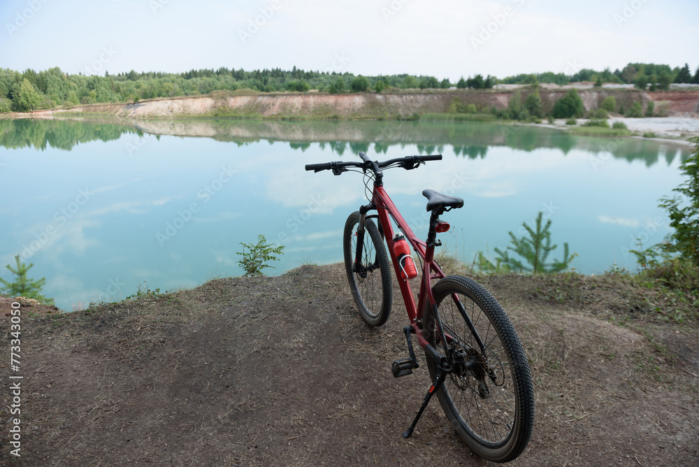 Fototapeta premium panoramic view of lake, bicycle in foreground