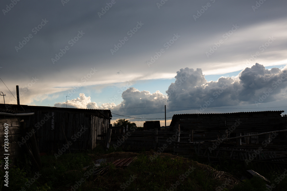 Beautiful clouds in the blue sky over the village, nature background in summer Beautiful clouds in the blue sky over the village, nature background in summer
