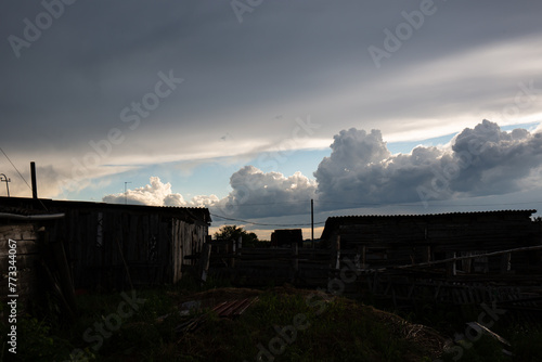 Beautiful clouds in the blue sky over the village, nature background in summer