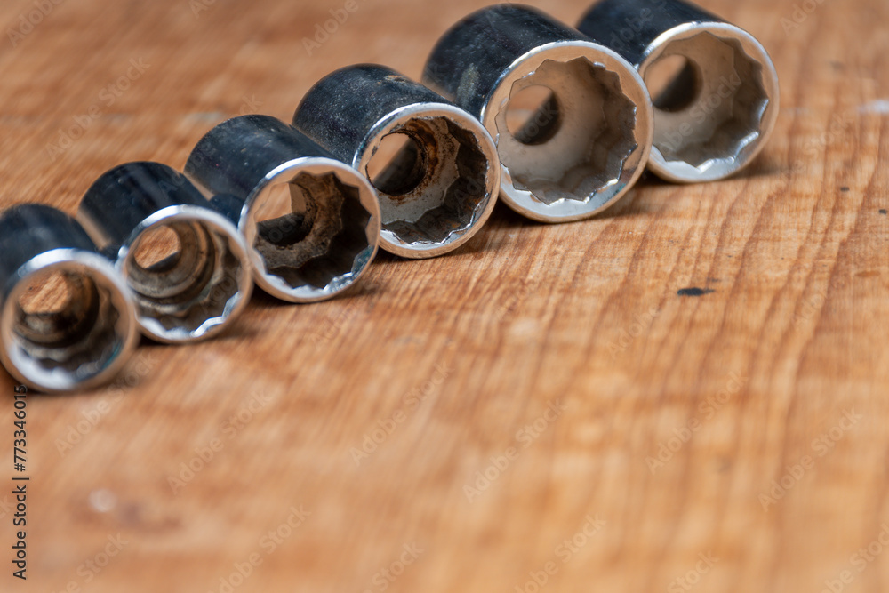 Series of tubular keys of different sizes in rustic wood.
