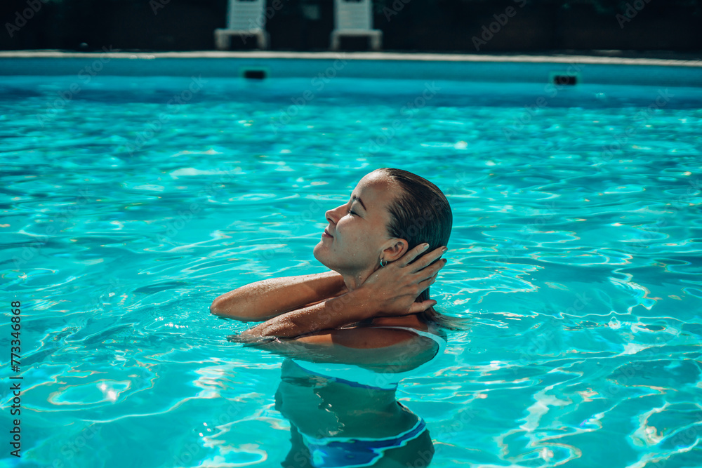 woman In bikini at swimming pool on a sunny day,bright tone,Fashion bikini pose concept.