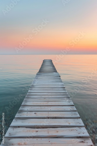 Wooden Dock Extending Into the Ocean at Sunset