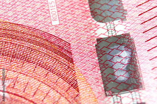 Close-up of a 10 euro banknote fragment with the portrait hologram. Macro photography. photo