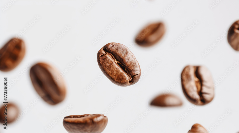 Flying roasted coffee beans isolated on white background with free place for text. Banner for restaurants, cafe, menu design Flying roasted coffee beans isolated on white background with free place for text. Banner for restaurants, cafe, menu design