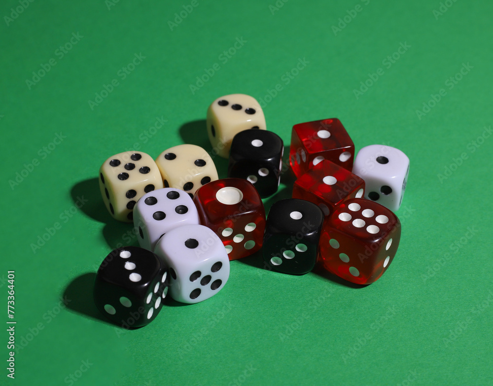 on a green background there are many dice of different colors and sizes on a green background there are many dice of different colors and sizes