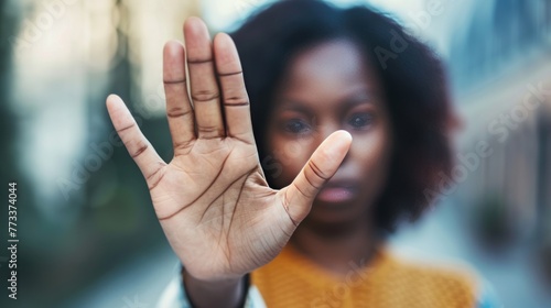 Close up focus African woman show palm hand opposes racial or gender discrimination, make stop gesture, sign of protest, female against domestic violence, abortion, bullying at school, say no concept © Mustafa