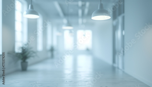 Modern office corridor with minimalist white design and elegant lighting fixtures.