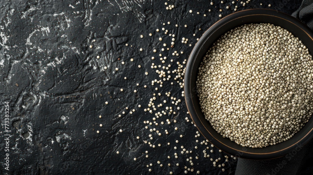 Top view many raw white quinoa seeds on bowl isolated black background. AI generated image - obrazy, fototapety, plakaty 