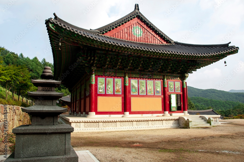 The beautiful wooden Buddhist building is decorated with various ornaments. A Buddhist temple in Korea. Traditional Korean architecture. South Korea.