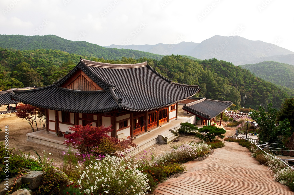 A traditional Korean style building. A wooden Buddhist building with a tiled roof decorated with carvings. A Buddhist temple in Korea. South Korea. A traditional Korean style building. A wooden Buddhist building with a tiled roof decorated with carvings. A Buddhist temple in Korea. South Korea.