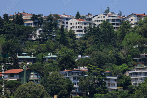 Beautiful houses and city streets of the southern city with green plants, public place in Turkey, on a summer sunny day