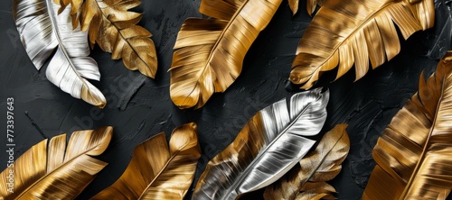 Gold and silver leaves contrast beautifully against a dark black background photo