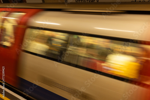 Tube, Subway train in motion blur leaving a London Underground train station.