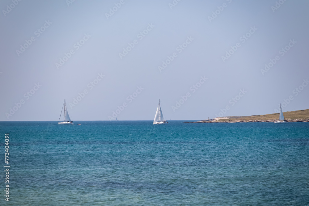 Luxury sailing boats floating in port of coastal town Medulin, Pomer Bay, Kamenjak nature park, Istria peninsula, Croatia, Europe. Cruising along coastline of Kvarner Gulf, Adriatic Mediterranean Sea