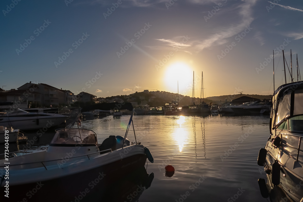 Sunrise view seen from idyllic port of coastal town Medulin, Istria peninsula, Croatia, Europe. Serene coastline of Kvarner Gulf in Adriatic Mediterranean Sea. Fishermen boats in golden morning hours