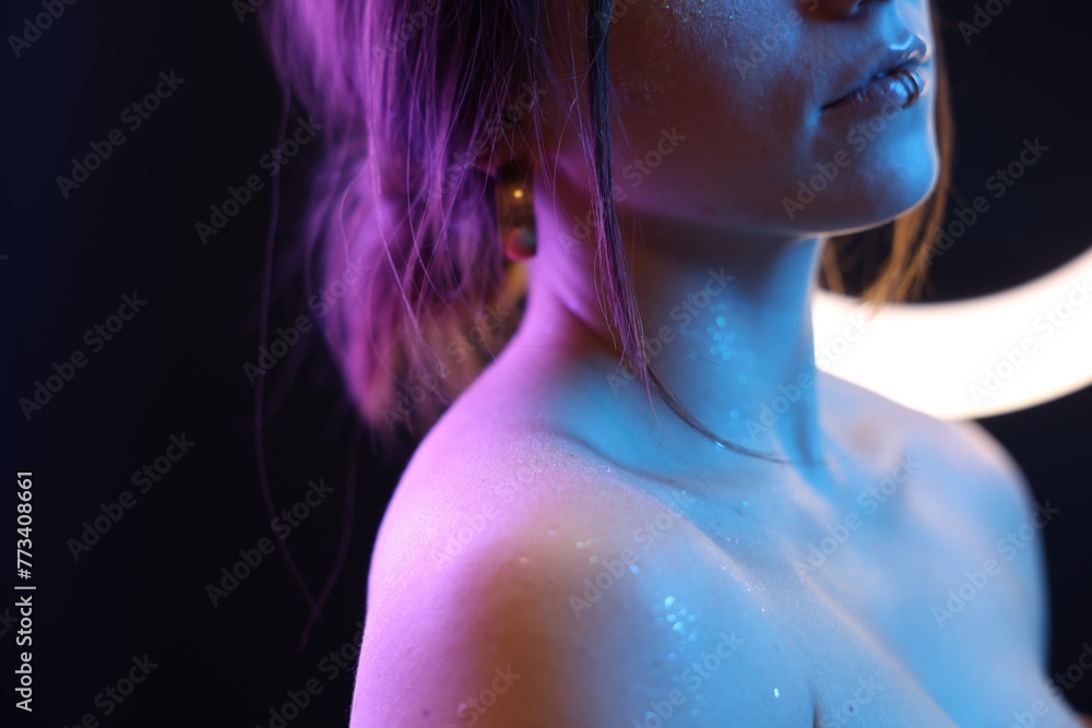 Woman on dark background in neon lights, closeup. Space for text Woman on dark background in neon lights, closeup. Space for text