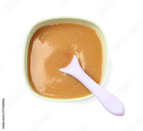 Tasty baby food and spoon in bowl isolated on white, top view