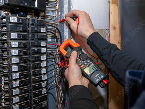 Home inspector testing home garage circuit breaker.