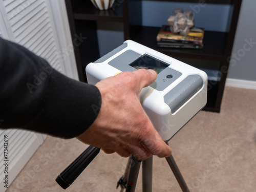 Home inspector doing a radon test setup in the lowest bedroom of a home.