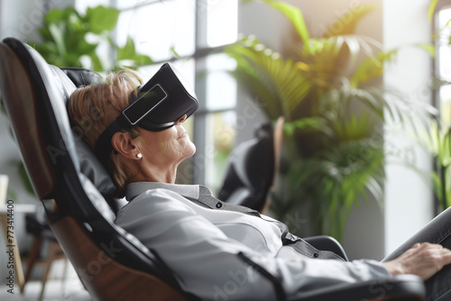 Person enjoys entertainment with VR glasses while lying on armchair photo