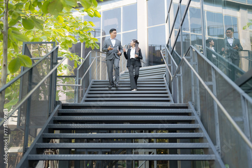 Business colleagues conversing on staircase