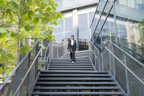 Confident businesswoman descending outdoor stairs © Naypong Studio