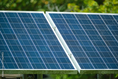 Solar photovoltaic panels mounted on stand-alone frame on backyard ground for generating of clean ecological electric energy. Concept of autonomous house