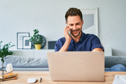 Man talking on the phone while forking from home